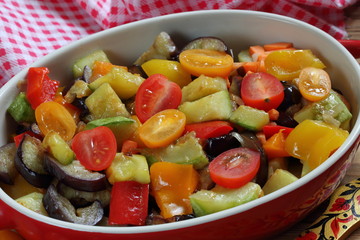 Vegetable stew with eggplant and zucchini on a wooden background