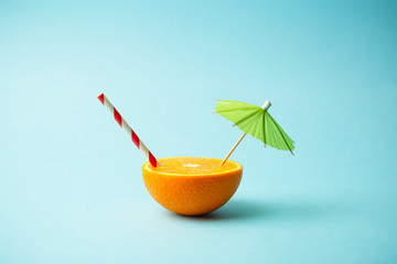 Food summer minimal concept. Orange juice and juicy tropical fruits on a light colored background