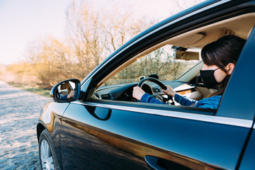 Woman in the medical mask in car. coronavirus, disease, infection, quarantine, covid-19