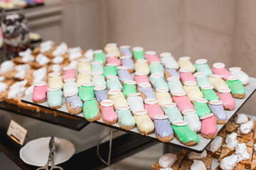 sweet and colorful eclair on glass. french eclair with word winner on top. hight angle view