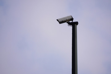 CCTV camera on the street, security in the city. covert shooting of what is happening. modern technologies and equipment. Road safety and monitoring of road users