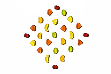 Colorful jelly candies in fruits shapes. Top view of positive and sweet composition on white background.