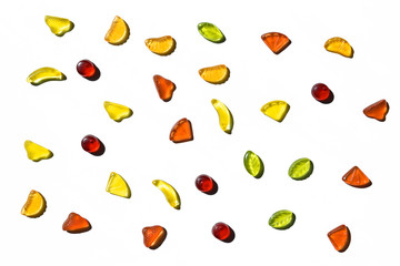 Colorful jelly candies in fruits shapes. Top view of positive and sweet composition on white background.