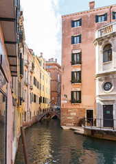 Water channels of Venice city. Facades of residential buildings overlooking the small canal in Venice, Italy.