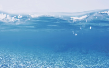 Naklejka na ściany i meble Unfocused underwater split view of Greek sea with pebbles