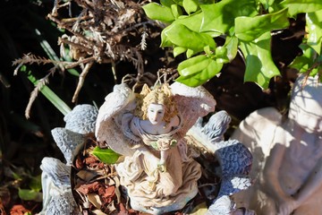 A statue surrounded by green leaves!