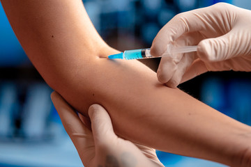 Doctor Vaccinating Patient From SARS Coronavirus, 2019-nCoV In Modern Hospital. Vaccine Trials. Immunization