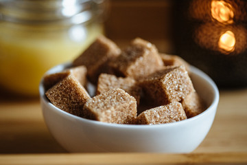 Close up photo of brown sugar bricks in a bowl, stylish food photo