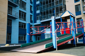 Fototapeta na wymiar An empty playground for children in the yard. Fenced territory, coronavirus