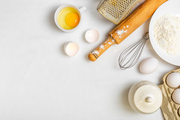 Fototapeta na wymiar cooking pancake on white background top view ingredients for making