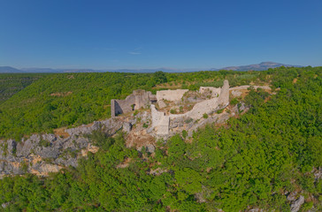 Fototapeta na wymiar Drone aerial view of the archaeological remains of the medieval fort Necven, located on the west side of mountain Promina on top of the canyon of the river Krka in Dalmatian Zagora in Croatia.