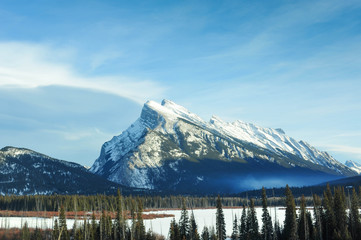 Mount Rundle towers over the city of Banff, nestled in the valley at Banff National Park, Alberta.