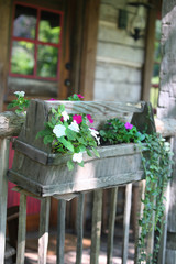 Fototapeta na wymiar old rustic wooden windowbox with flowers 