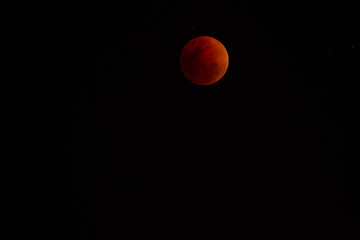 The moon that is covered by the shadow of the world is dark red