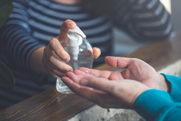 Woman putting hand sanitizer in her hand