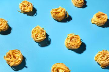 Uncooked pasta pattern  on blue background. Colorful background top view