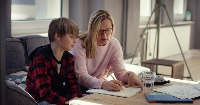 Mother explaining son his homework