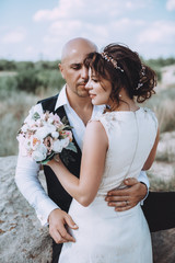 Bride and Groom at wedding Day walking Outdoors on spring nature. Bridal couple, Happy Newlywed woman and man embracing . Loving wedding couple outdoor. 