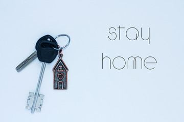 bundle of keys with a keychai in in the form of a house. Inscription stay home
