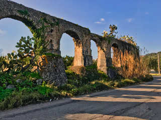 Fototapeta na wymiar Arches of an ancient aqueduct that supplied a mill, Italy.