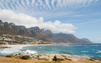 Fototapeta na wymiar Tourists at Camps Bay Beach, Cape Town, South Africa