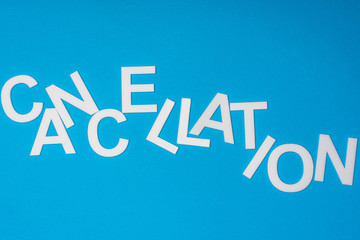 Top view of cancellation lettering isolated on blue