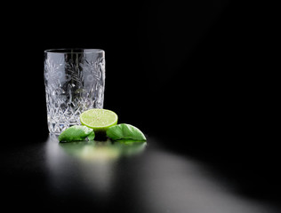 Glass, crystal glass, for homemade cocktails with lime and basil