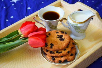 Breakfast in bed with a bouquet of flowers