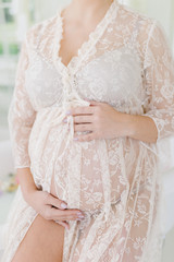 Pregnant woman in peignoir.
Girl in white lingerie.