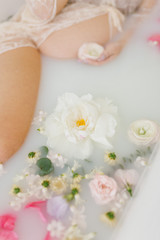 Fototapeta na wymiar pregnant woman in a bath with flowers