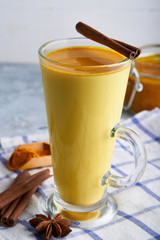 Turmeric milk. Cooked golden milk in a glass