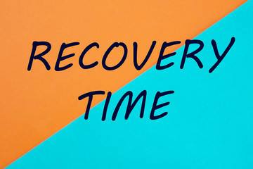 RECOVERY TIME words written on a beautiful sheet of paper is yellow blue