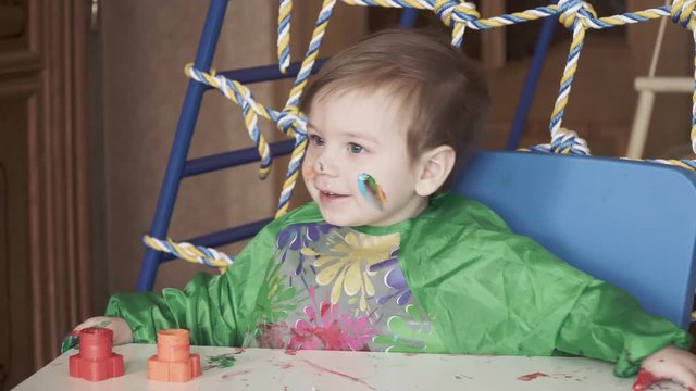 Boy at the table with paint