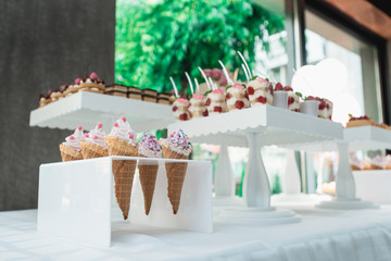 Waffle cones with ice cream on table