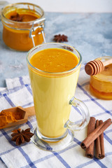 Turmeric milk. Cooked golden milk in a glass