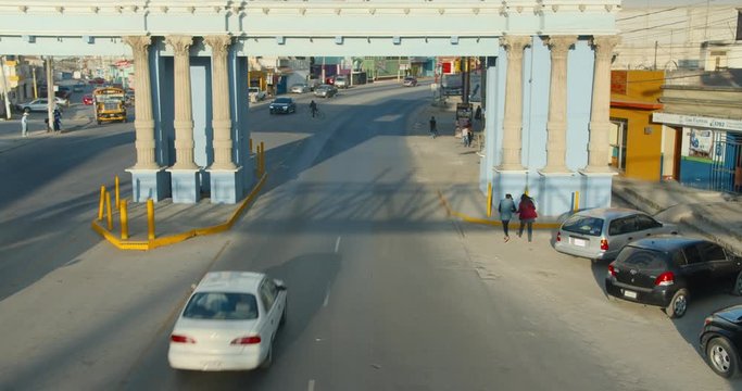 End of Day Commuters Leaving Xela Quetzaltenango through Archway Time-lapse