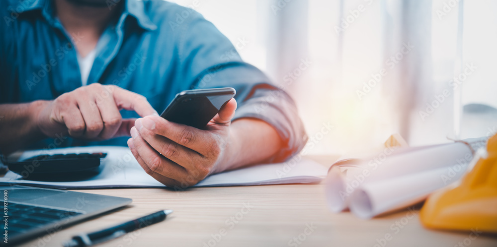Leinwandbilder Hand man using smartphone for Searching Browsing Internet Data Information Networking Concept. Find information about building a house.