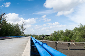 Blue pipe that is laid out in a long line for transporting fuel. From the marina to transport the river