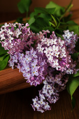 A branch of lilac lies on the table