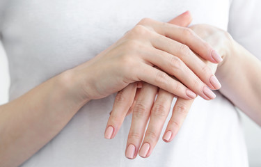 Close up of female hands with gently beige manicure. Hand skin care.
