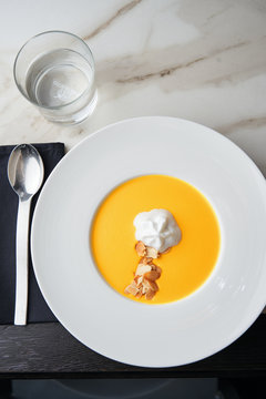 Gourmet puree of carrot soup with whipped coconut cream