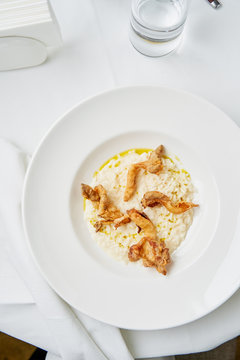 Creamy mascarpone risotto with oyster mushrooms on white table