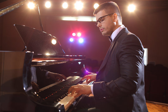 Elegant Young Man Playing A Piano On Stage