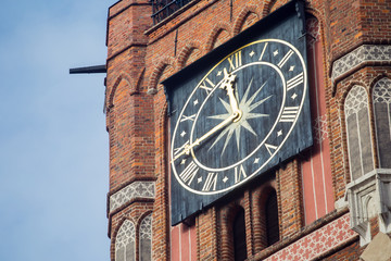 Closeup of a clock on a town hall tower, Torun, Poland