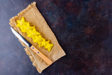 Carambola on the wooden board. Star Fruit (Averrhoa carambola L.) on burlap. Yellow fruit carambola...