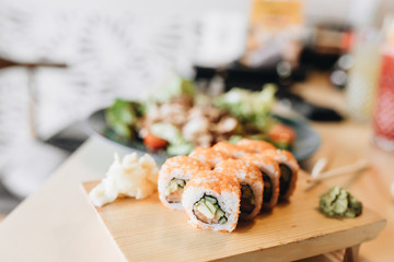 Fresh delicious Philadelphia sushi on wooden table