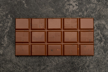 chocolate bar with nuts on a dark background