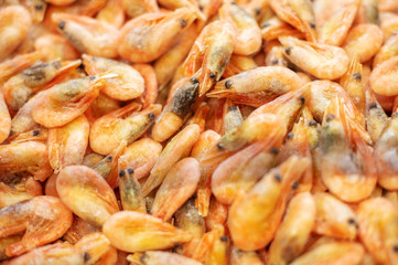 red frozen shrimp in the supermarket refrigerator by weight. Delicious wholesome seafood in the store.