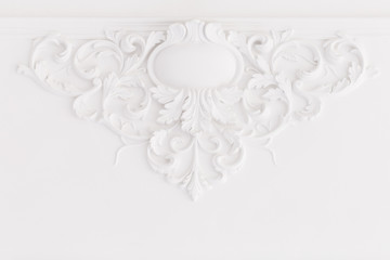 Beautiful ornate white decorative plaster moldings in studio.