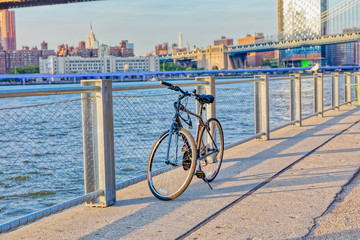 Bicycle in front of the Brooklyn Bridge Park fence and Manhattan panorama